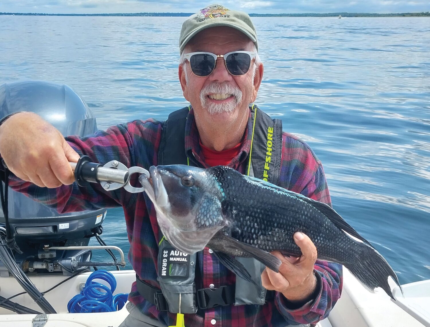 FISH SANDWICH: Gary Vandemoortele of Smithfield with his first black sea bass of the season, a 21-inch fish caught off Warwick Light on Monday. Gary said, “Guess we’re having fresh fish sandwiches for dinner tonight.” (Submitted photo)